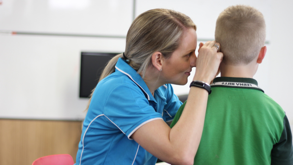 Boy Having Ear Examined By Hearing Screener