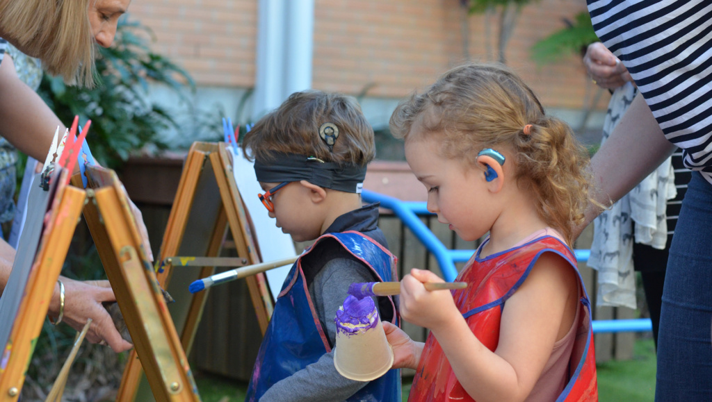 Children Painting At Group Program