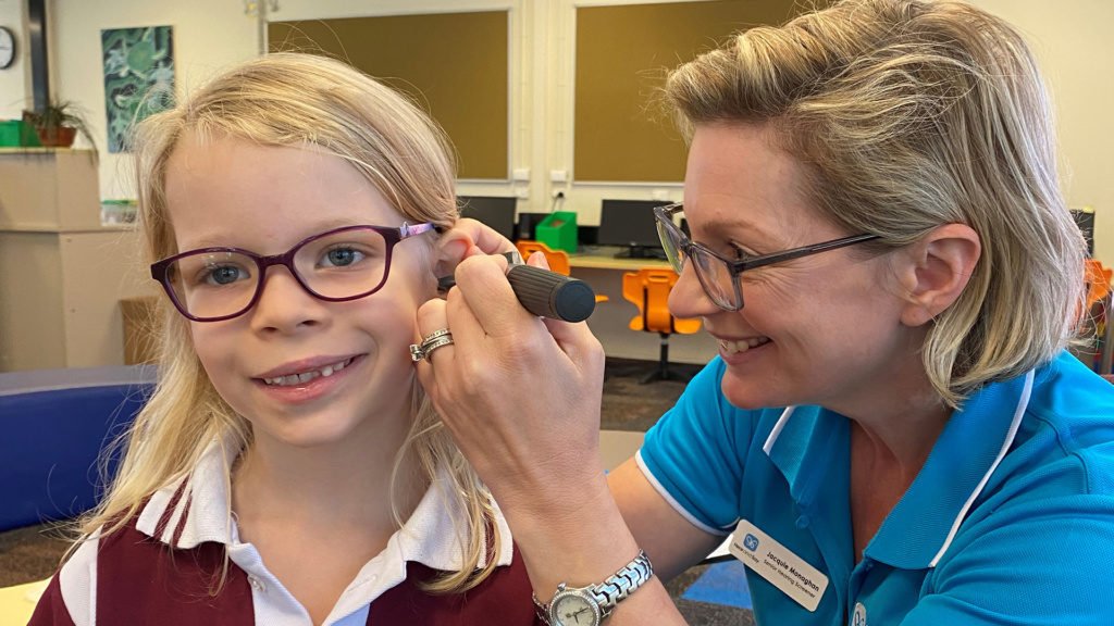 Girl Having Ear Examined By Hearing Screener