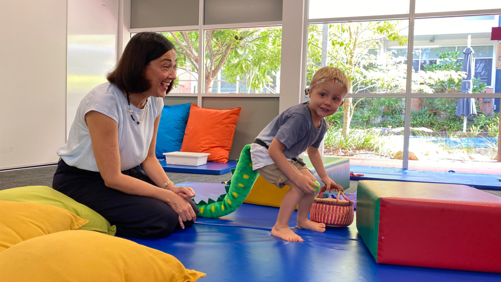 Occupational Therapist With Boy Playing A Game