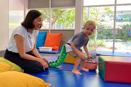 Occupational Therapist With Boy Playing A Game