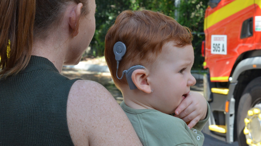 Lady Holding Child With Cochlear Implant