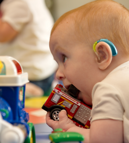 Img Baby With Hearing Aid At Playgroup