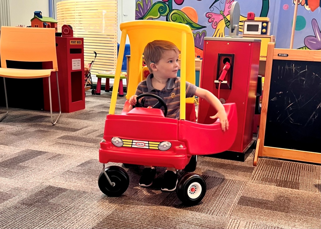 Boy at playgroup in toy car